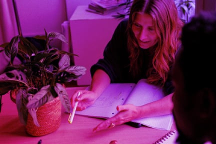 Woman talking to someone across from her at a table