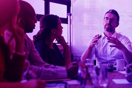 Man talking to a group of people at a table